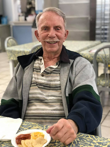 An older gentleman enjoying a moment at a restaurant.