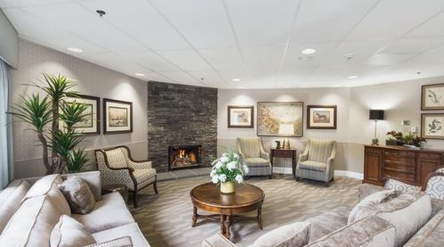 A cozy living room with a fireplace, elegant seating, and modern decor.