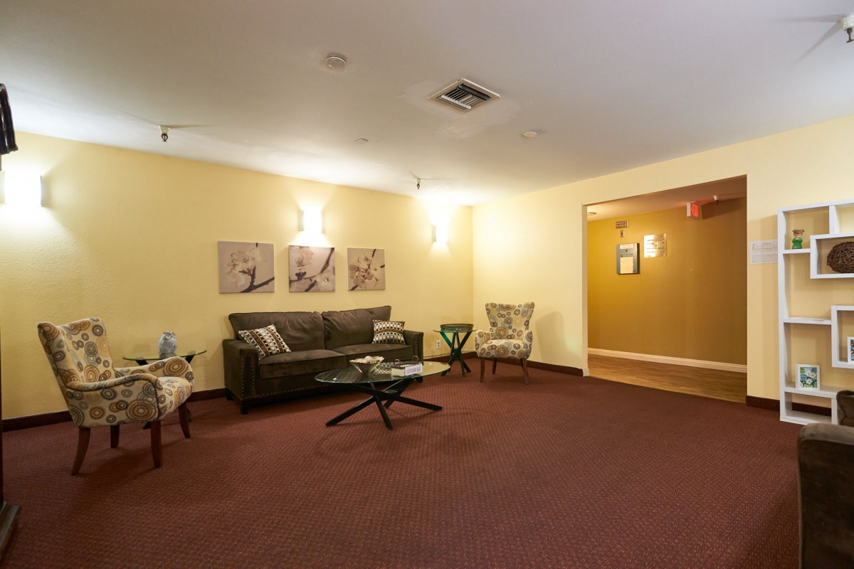 A comfortable lobby area with seating, artwork, and warm lighting.