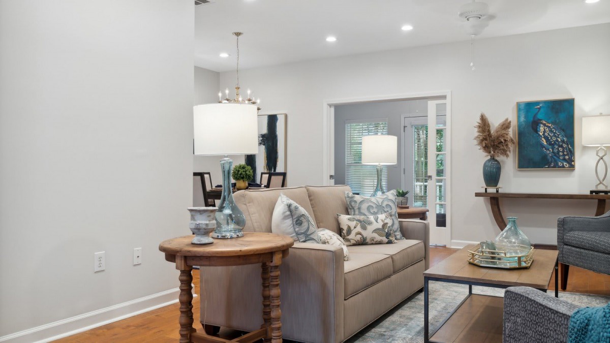 A modern living room featuring a comfortable sofa, stylish lamps, and chic home decor.