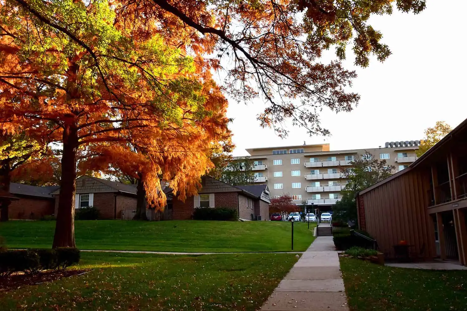 A scenic view of a residential building surrounded by vibrant autumn foliage.