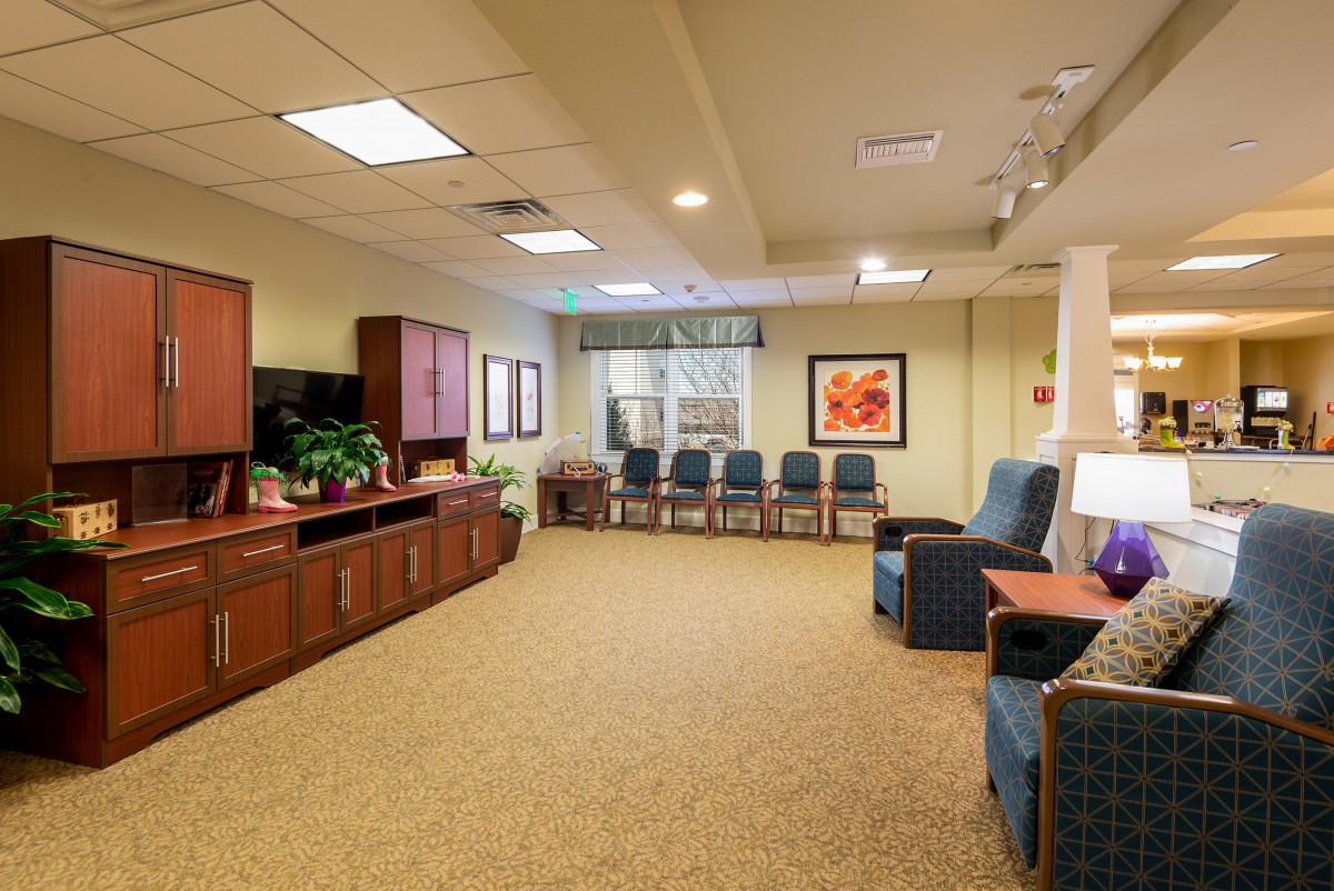 A spacious waiting room with comfortable seating and warm decor.