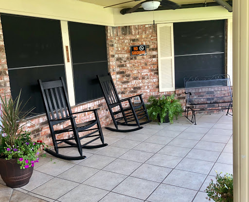 A cozy porch featuring rocking chairs and a serene atmosphere for relaxation.