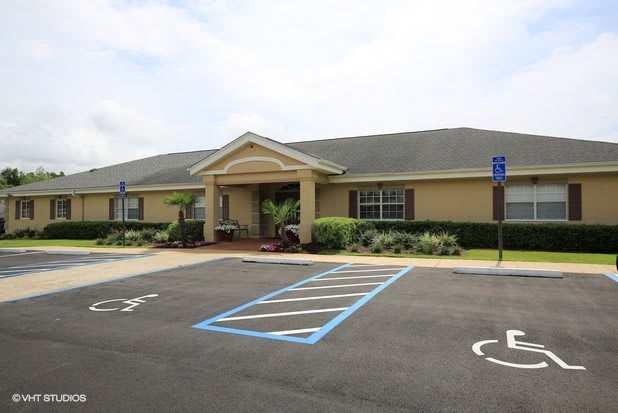 A single-story building with a parking lot featuring designated handicap spaces.