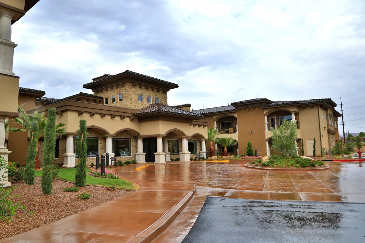 A luxurious resort building with a grand entrance and a cloudy sky backdrop.