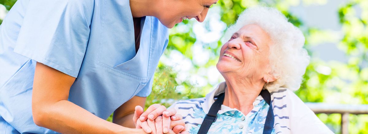 A nurse providing compassionate care to an elderly woman.