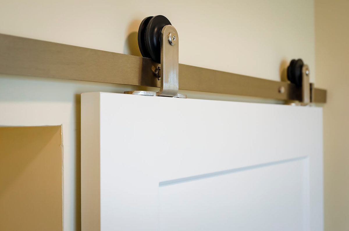 A close-up view of a sliding barn door mechanism.