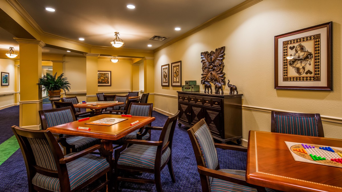 A well-appointed meeting room with tables, chairs, and decorative artwork on the walls.
