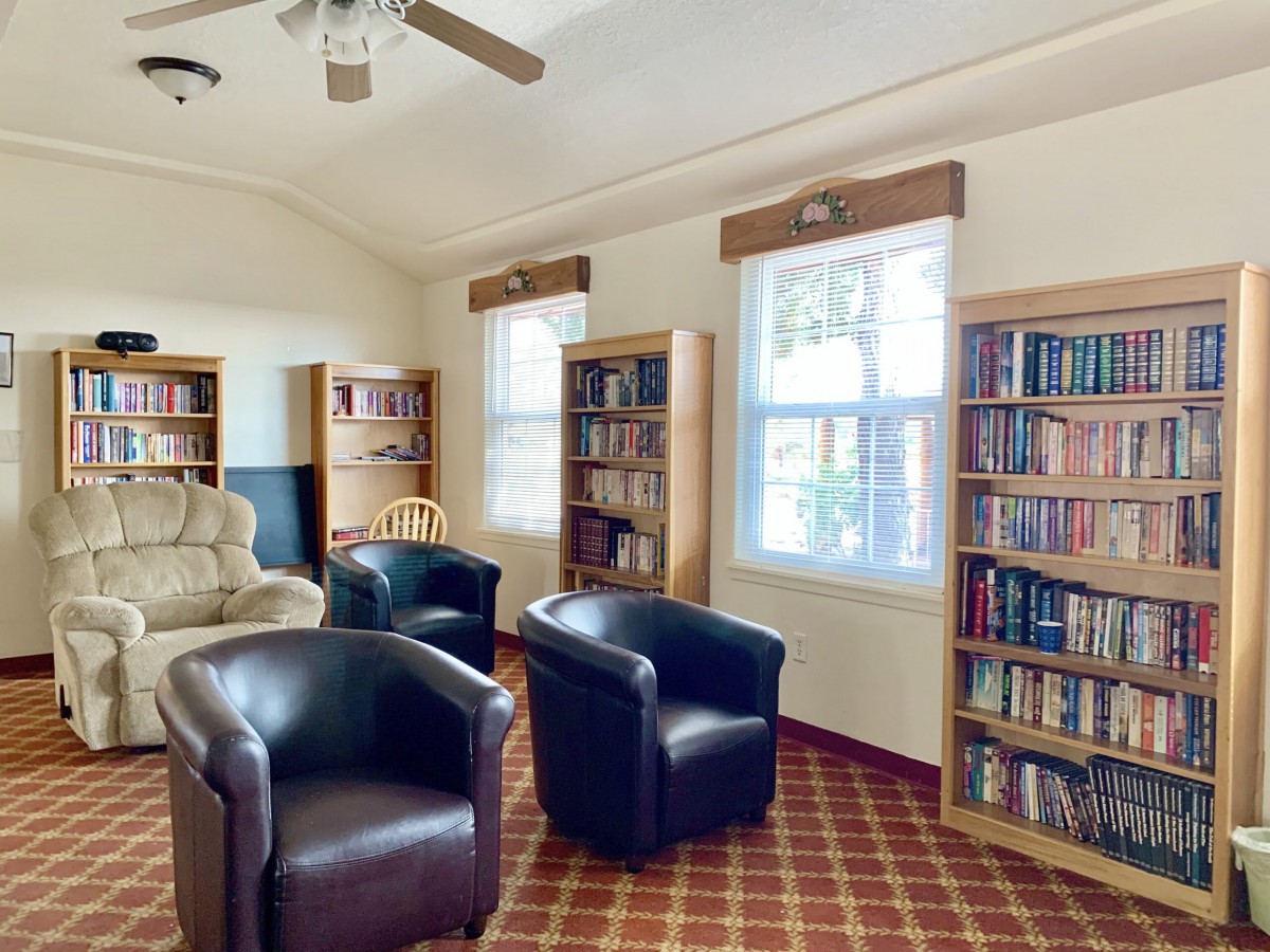 A cozy reading room with bookshelves and comfortable seating.