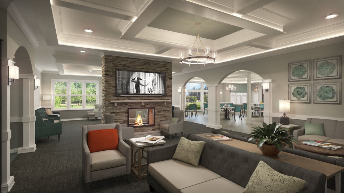 A modern living room with a cozy fireplace, stylish sofa, and elegant chandelier.