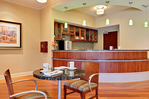 A contemporary lobby area featuring a reception desk and a cozy seating arrangement.