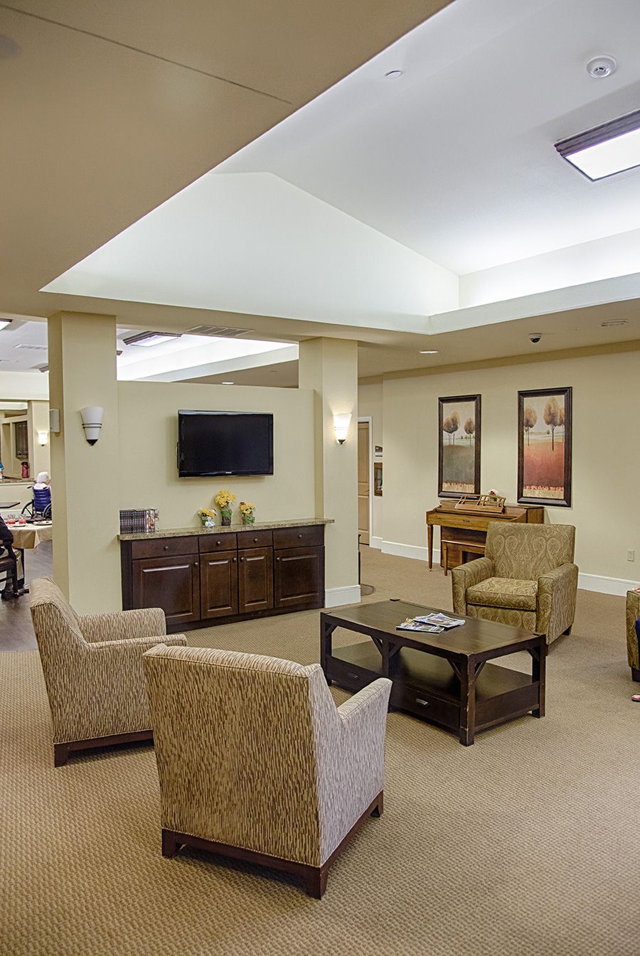 A cozy living room with comfortable seating, wall-mounted television, and tasteful decor.
