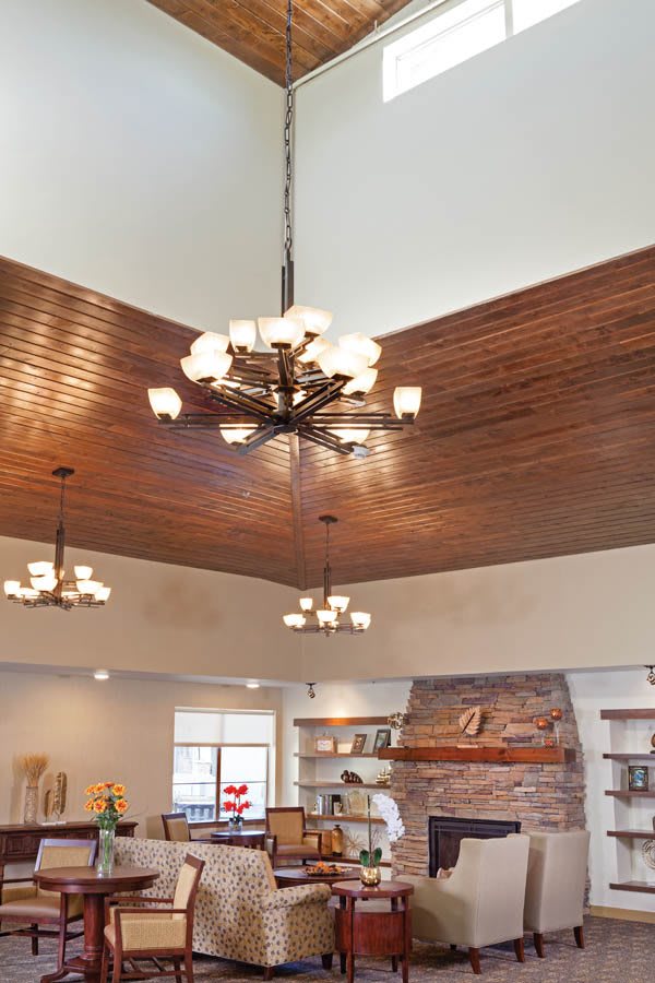 Elegant interior featuring multiple chandeliers and a wooden ceiling.