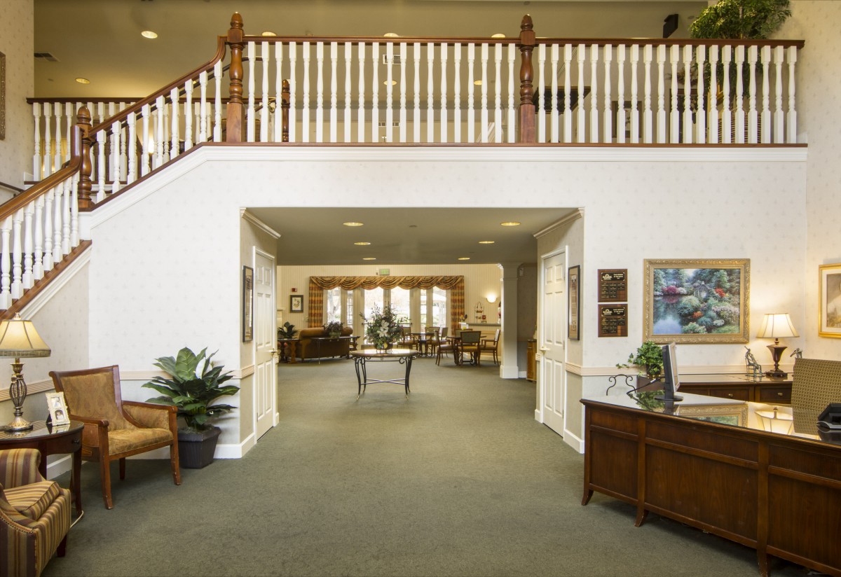 A spacious and warmly decorated lobby area with comfortable seating and elegant furnishings.