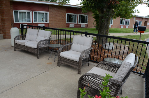 A cozy outdoor seating area featuring comfortable chairs and a small table, perfect for relaxation.