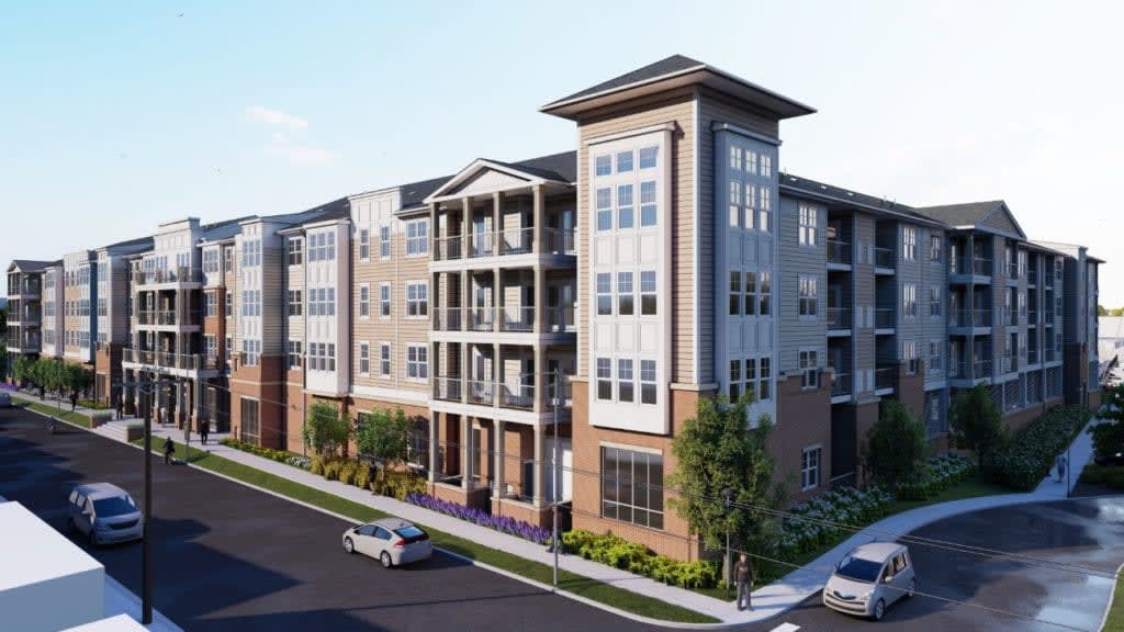 A modern residential apartment building with multiple floors and balconies, set in an urban environment.