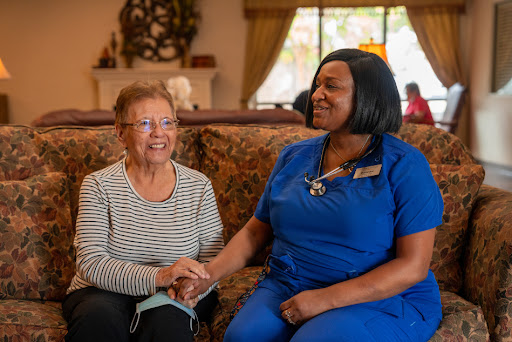 A warm moment of connection between a caregiver and an elderly resident, showcasing compassion and care.