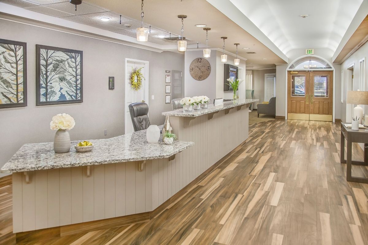 A modern office reception area with stylish wooden flooring and elegant decor.