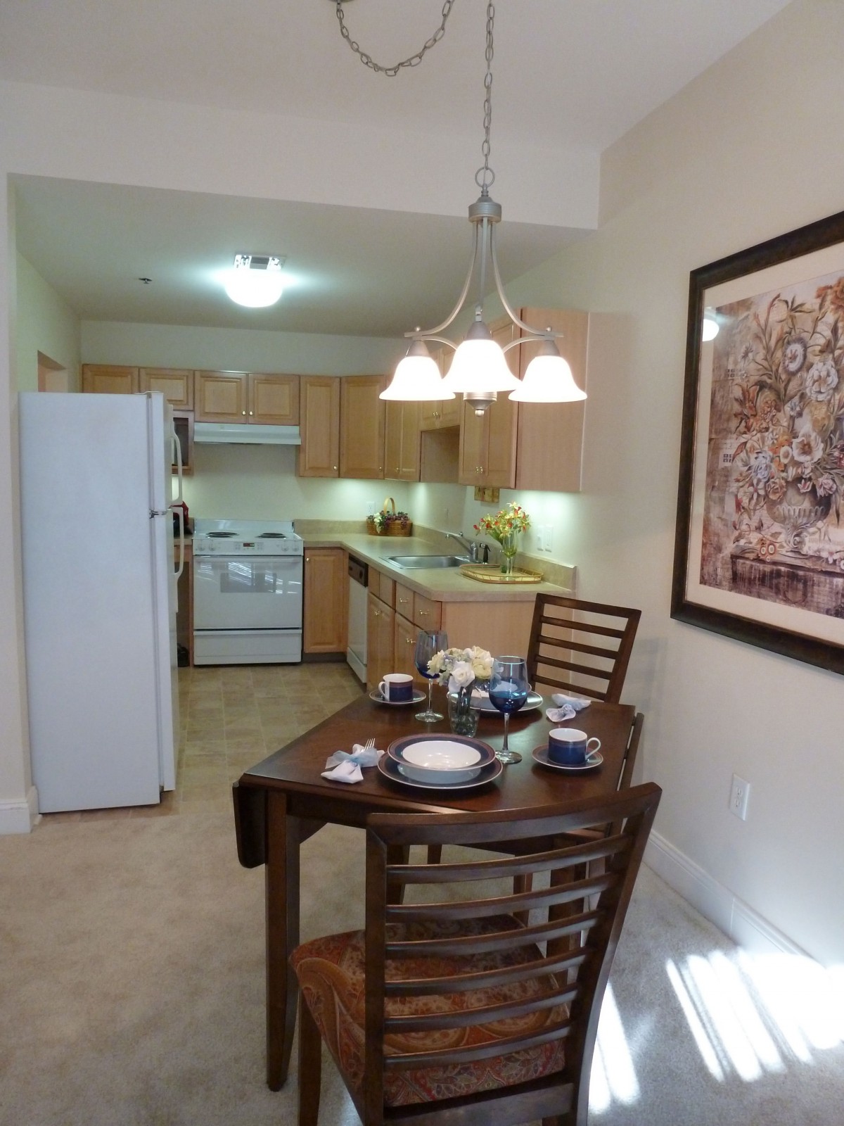 A cozy kitchen and dining area with a well-set table and warm lighting.