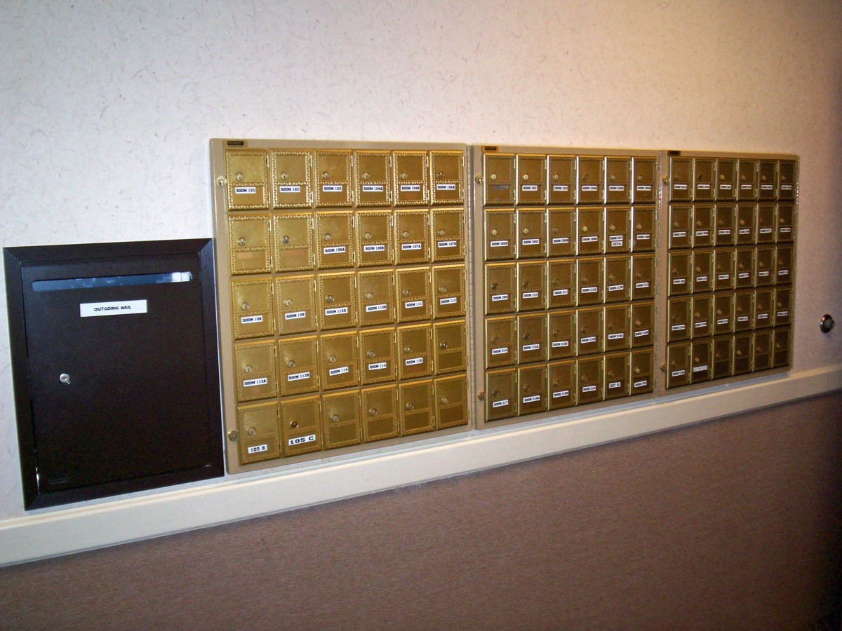 A wall of mailboxes in a post office setting.