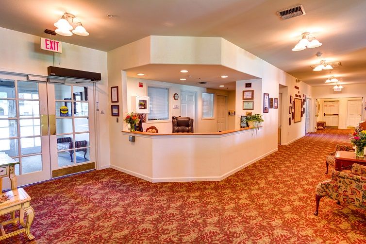 A welcoming reception area with a central desk and carpeted flooring.