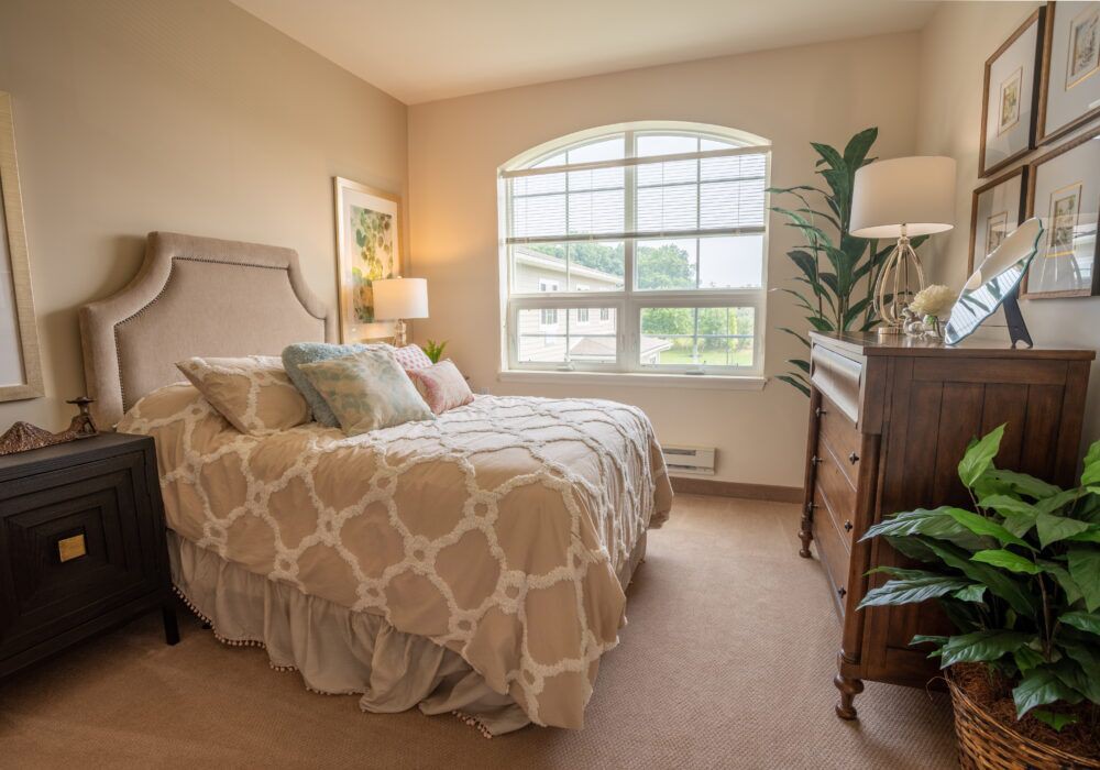 Cozy bedroom with a large window and elegant decor.