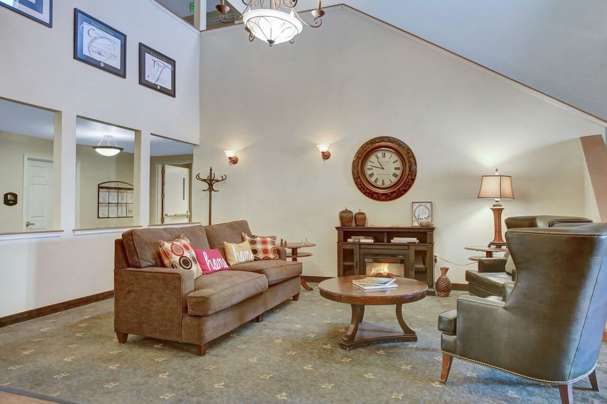 A cozy living room with a brown sofa, coffee table, and elegant decor.