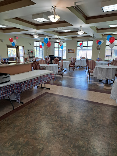 A spacious dining area decorated with balloons, ready for a gathering or celebration.