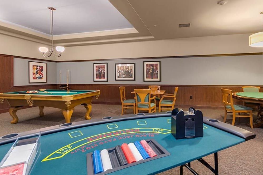 A cozy game room featuring a casino table and pool table for recreation.
