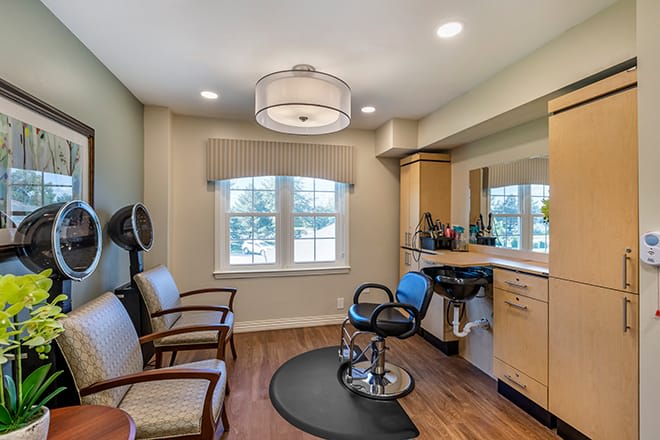 A cozy hair salon interior with styling station and comfortable seating.