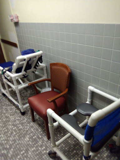 A row of various chairs in a healthcare setting.