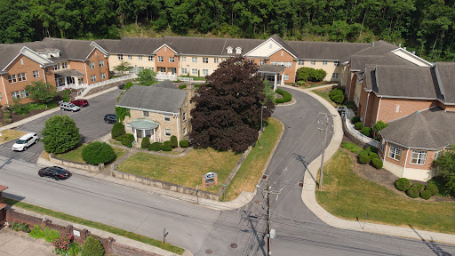 An aerial view of a residential area showcasing buildings and surrounding greenery.