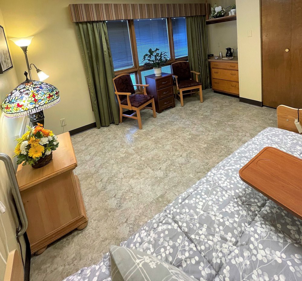 A cozy bedroom with elegant furnishings and floral decorations.