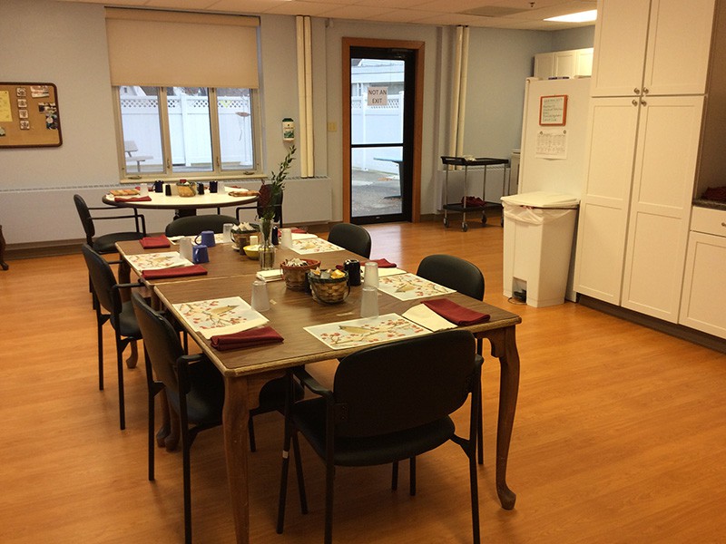 A dining room with a neatly set table and chairs, ready for a meal.