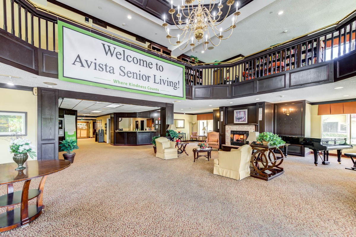 A welcoming lobby area of Avista Senior Living featuring comfortable seating and a fireplace.