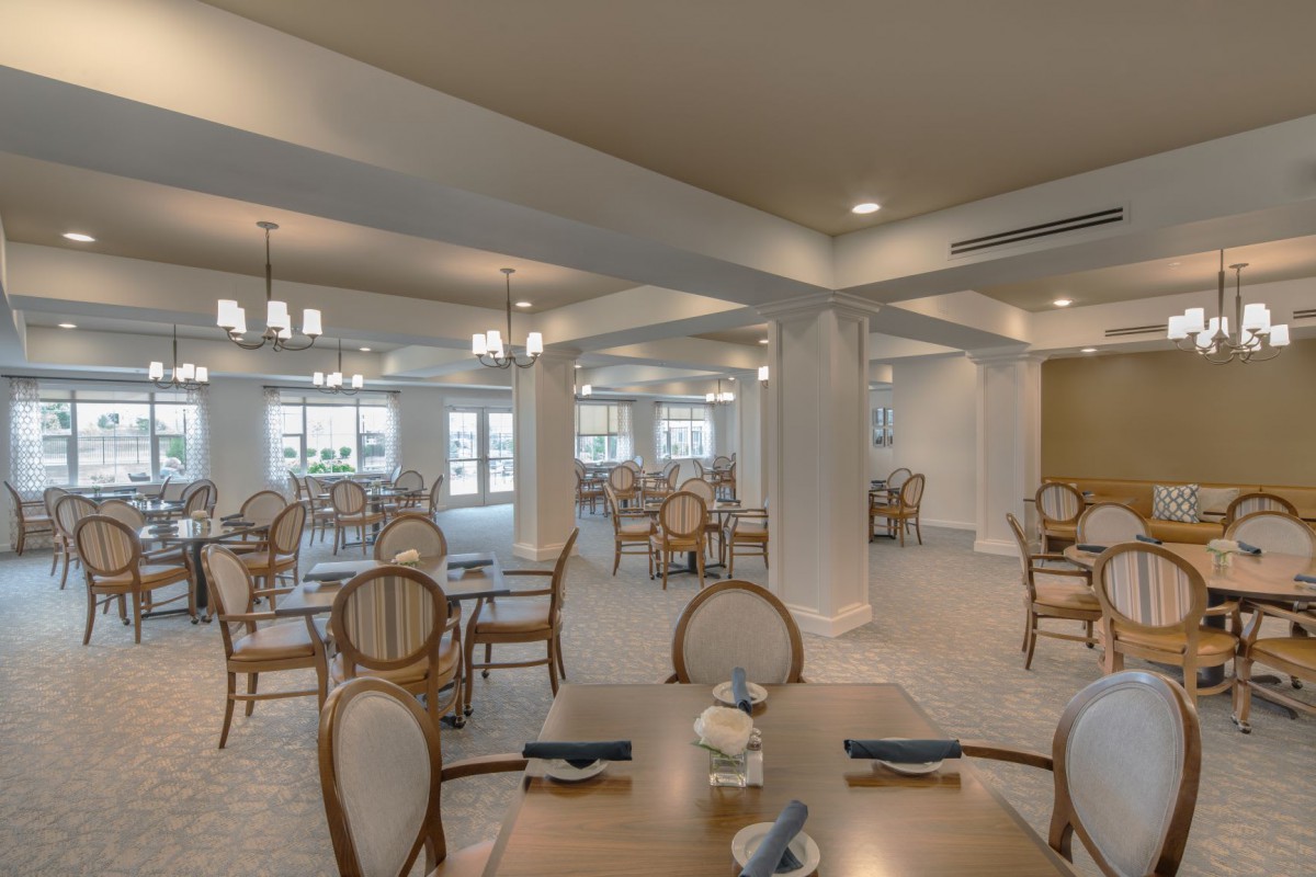 An elegant and spacious dining room with neatly arranged tables and chairs.