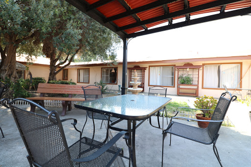 A cozy outdoor seating area featuring a table and chairs, surrounded by a charming courtyard.