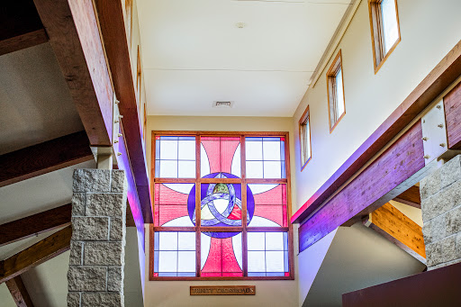 A beautifully designed stained glass window illuminating the interior space with vibrant colors.