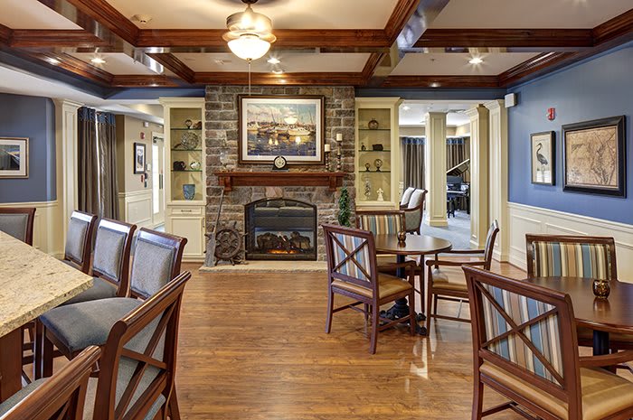 A cozy living room with a stone fireplace and elegant furniture.