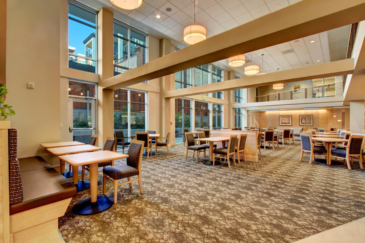 A spacious and modern dining area with large windows and elegant lighting.