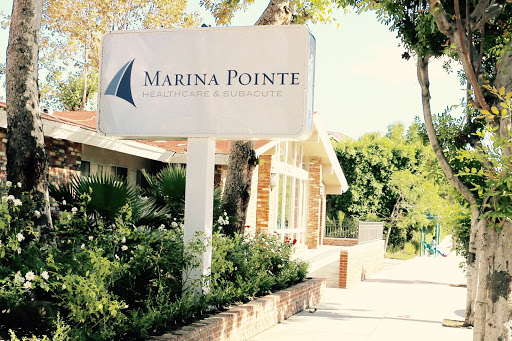 A sunny day view of the Marina Pointe sign, welcoming visitors to the community.