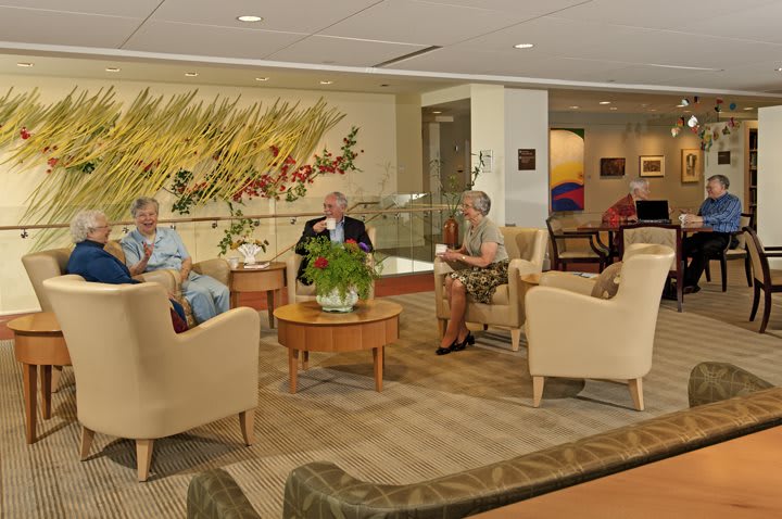 A group of seniors relaxing in a comfortable lounge area.