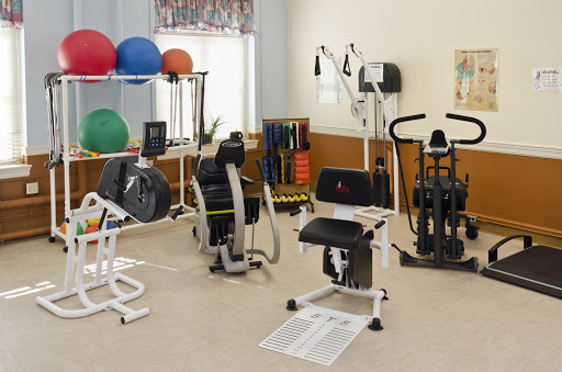 A well-equipped fitness area featuring various exercise machines and equipment for rehabilitation and strength training.