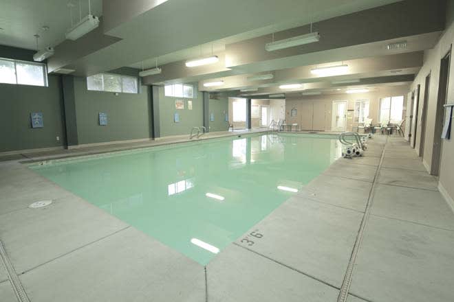 An empty indoor swimming pool with a calm and serene atmosphere.