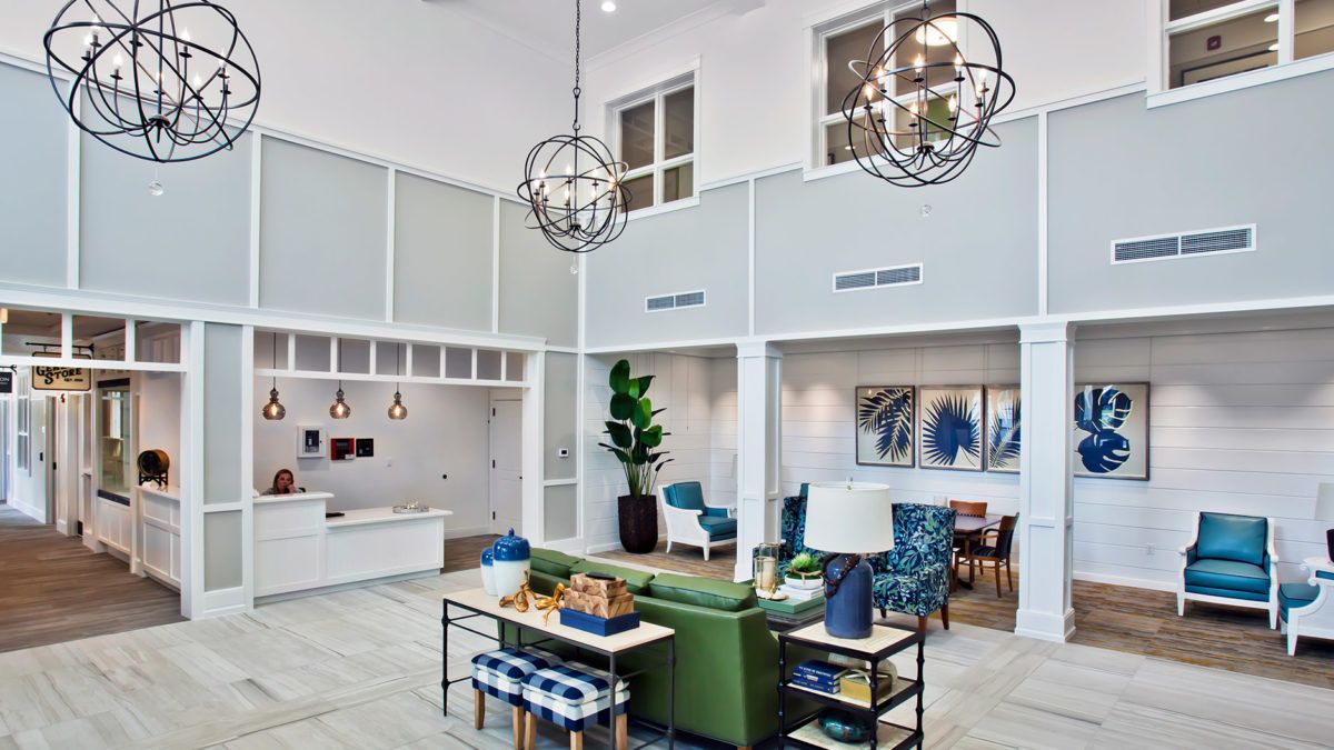 A modern lobby with stylish furniture and elegant chandeliers.