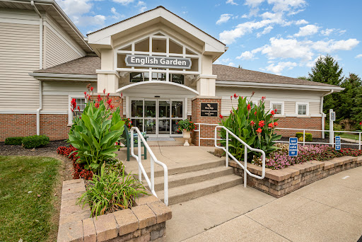A welcoming community center entrance surrounded by vibrant landscaping.