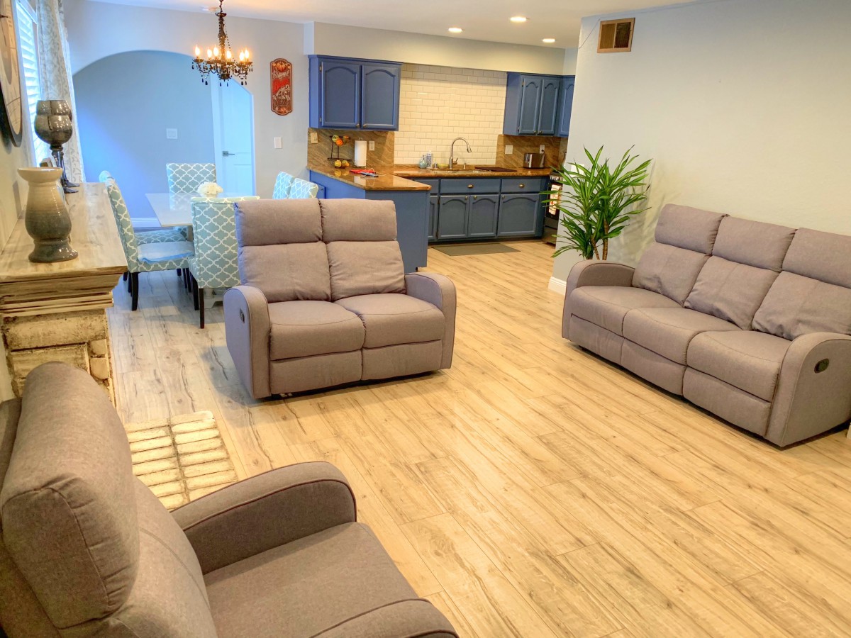 A modern open-plan living area with comfortable seating and a stylish kitchen.