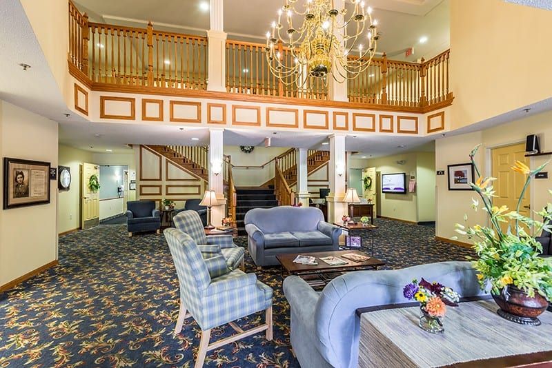 Elegant hotel lobby with a chandelier and comfortable seating.