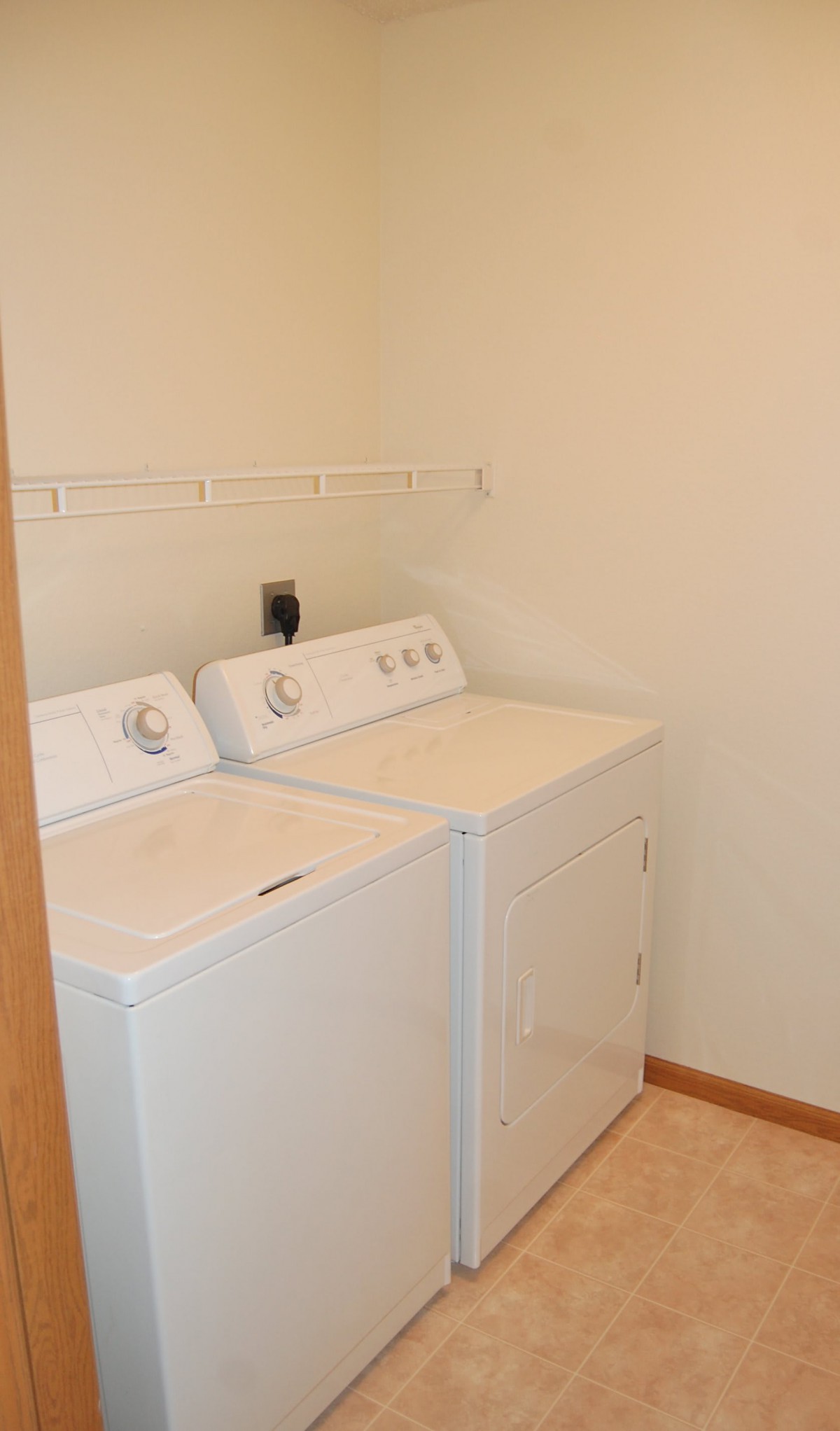 A small laundry room with a washer and dryer set.