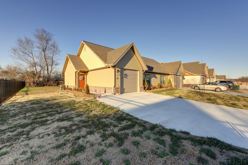 A suburban house with a driveway on a sunny day.